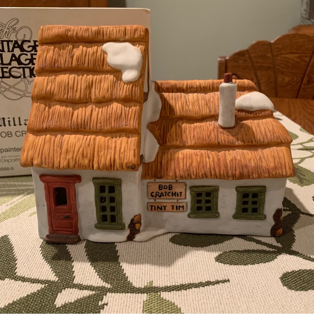 Bob Cratchett and Tiny Tim light up house. Dept 56, Dickens’ Village Series.